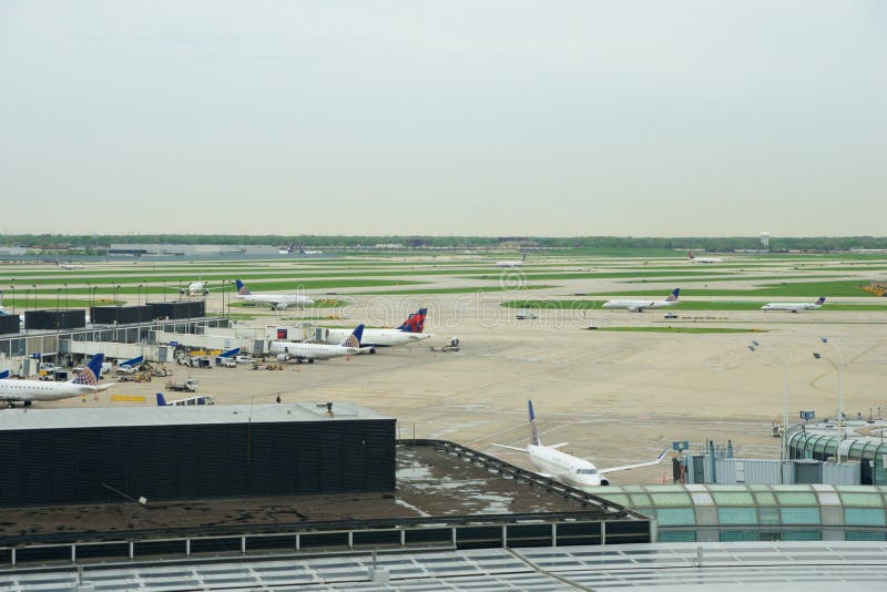 CHICAGO, ILLINOIS, UNITED STATES - MAY 11th, 2018: Several Airlines jet parking on gate position at Chicago O`Hare International Airport in the morning. CHICAGO, ILLINOIS, UNITED STATES - MAY 11th, 2018: Several Airlines jet parking on gate position at Chicago O`Hare International Airport in the morning.