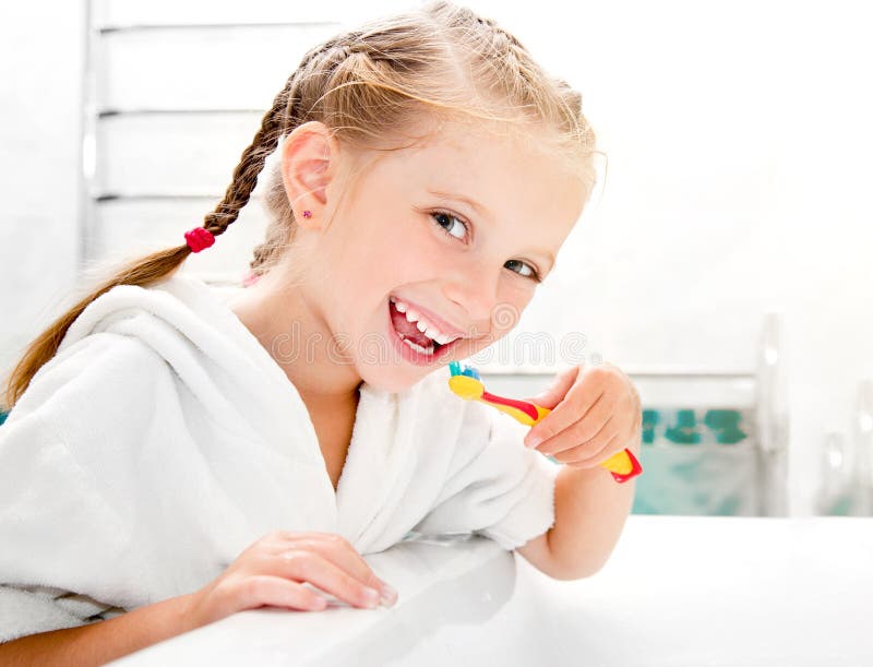 Little girl brushing teeth in bath. Little girl brushing teeth in bath