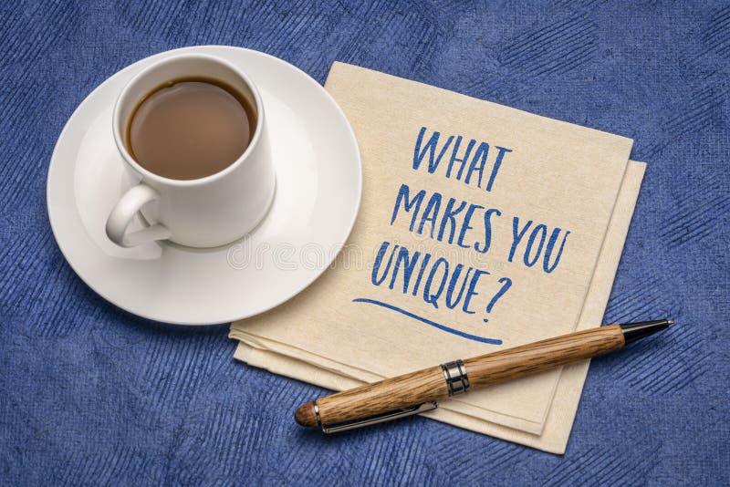 What makes you unique? Handwriting on a napkin with a cup of coffee. Personal branding and development concept. What makes you unique? Handwriting on a napkin with a cup of coffee. Personal branding and development concept