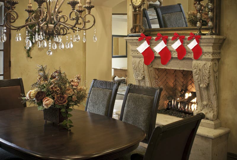 Red Christmas stockings hung on a fireplace mantel over a glowing fire for the holiday season. Red Christmas stockings hung on a fireplace mantel over a glowing fire for the holiday season