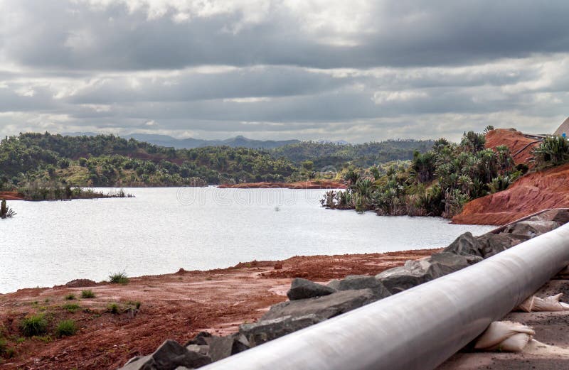 Mine tailings reservoir in Magadascar, receiving slurry through a pipeline from an ore processing plant. Mine tailings reservoir in Magadascar, receiving slurry through a pipeline from an ore processing plant.