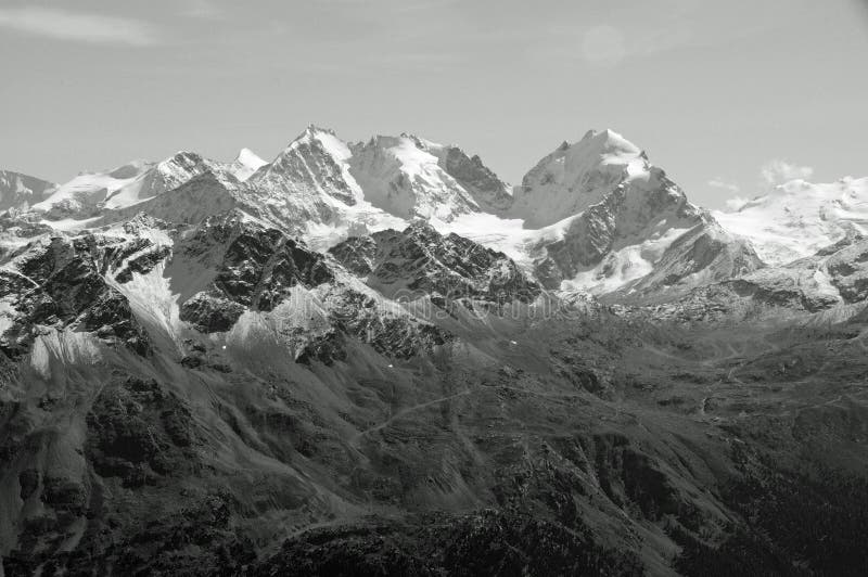 Swiss Alps: Snow mountain Panorama from Julier in the upper Engadin. Due to the global clima change the perafrost of the swiss alps is melting and causing a threat to the villages and people. Swiss Alps: Snow mountain Panorama from Julier in the upper Engadin. Due to the global clima change the perafrost of the swiss alps is melting and causing a threat to the villages and people