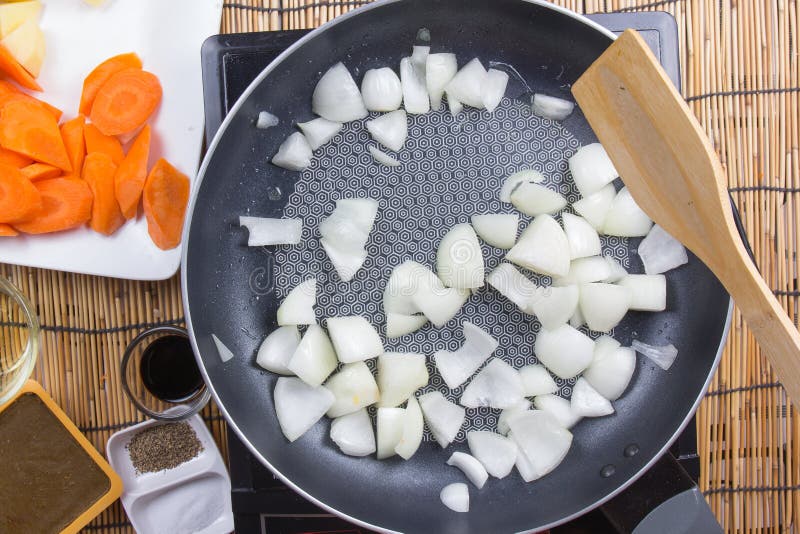 Шеф-повар stir-зажарил кусок лука в лотке для варить японский p стоковое изображение rf Шеф-повар stir-зажарил кусок лука в лотке для варить японский p стоковое изображение rf