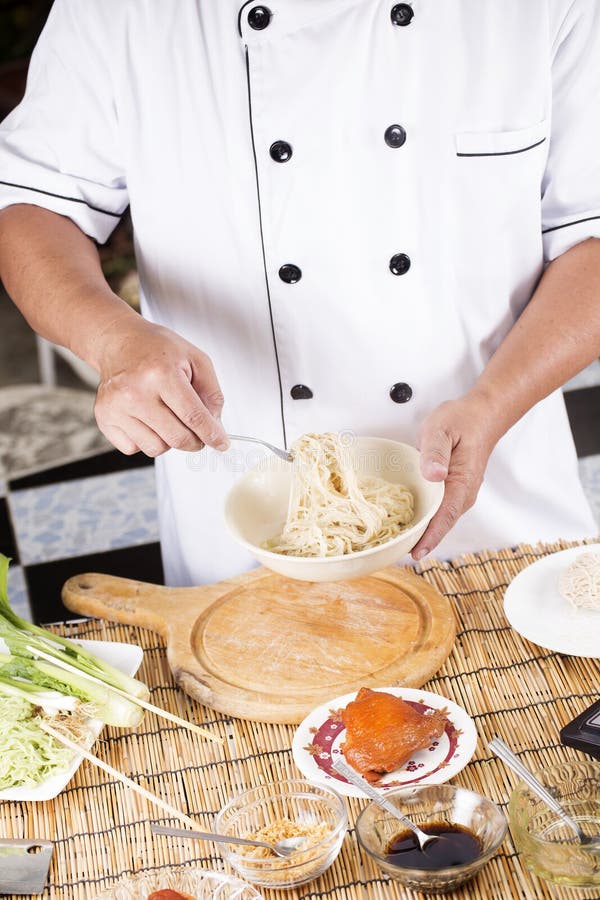 Chef holding the noodle from the bowl with fork / Cooking Noodle concept. Chef holding the noodle from the bowl with fork / Cooking Noodle concept