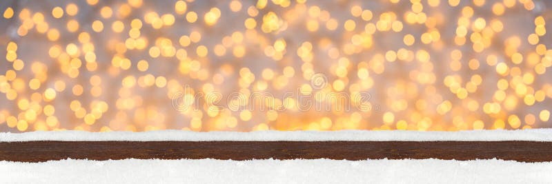 Wide panorama banner christmas xmas background with wooden snowy planks in front of bright illuminated lights bokeh. Wide panorama banner christmas xmas background with wooden snowy planks in front of bright illuminated lights bokeh