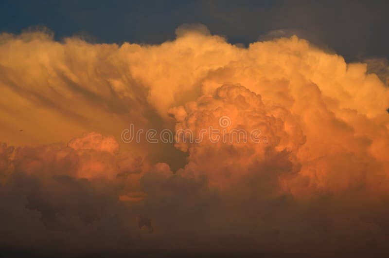 Storm clouds are lightened by the sun at sunset. Storm clouds are lightened by the sun at sunset.