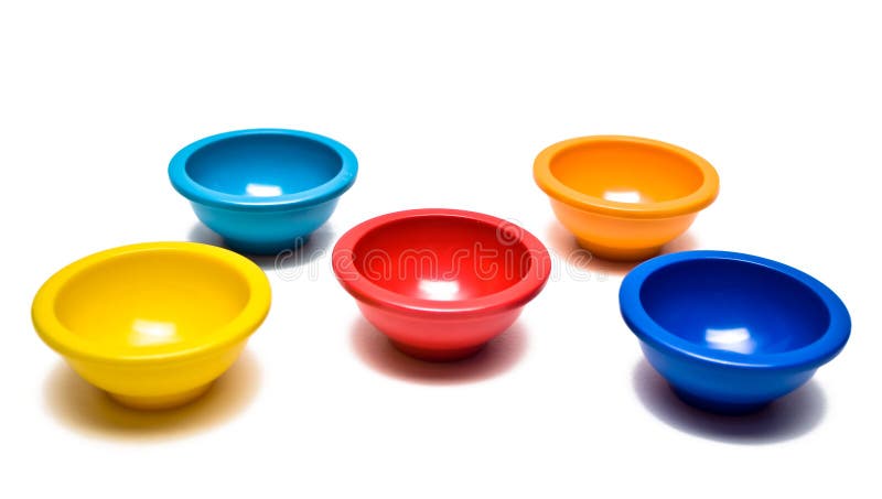 Colored pinch bowls in red, yellow, blue, and orange on white background. Colored pinch bowls in red, yellow, blue, and orange on white background.