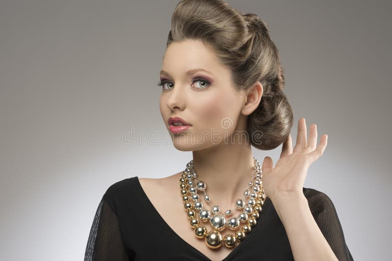 Close-up portrait of fashion pretty girl with brown elegant hair-style and bright big necklace. Close-up portrait of fashion pretty girl with brown elegant hair-style and bright big necklace.