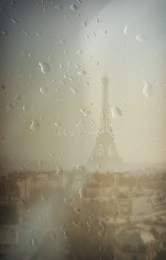 Textured image of Eiffel Tower on a grey rainy day, seen through a window with raindrops and blur effect. Book cover design. Textured image of Eiffel Tower on a grey rainy day, seen through a window with raindrops and blur effect. Book cover design