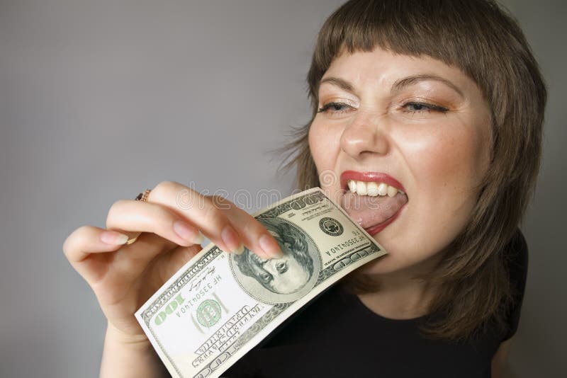 Woman with hand of $100 and it licks by the tongue. Woman with hand of $100 and it licks by the tongue.