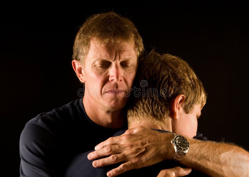 Father hugs his teenage son - comforting, consoling, reconciliation. Father hugs his teenage son - comforting, consoling, reconciliation