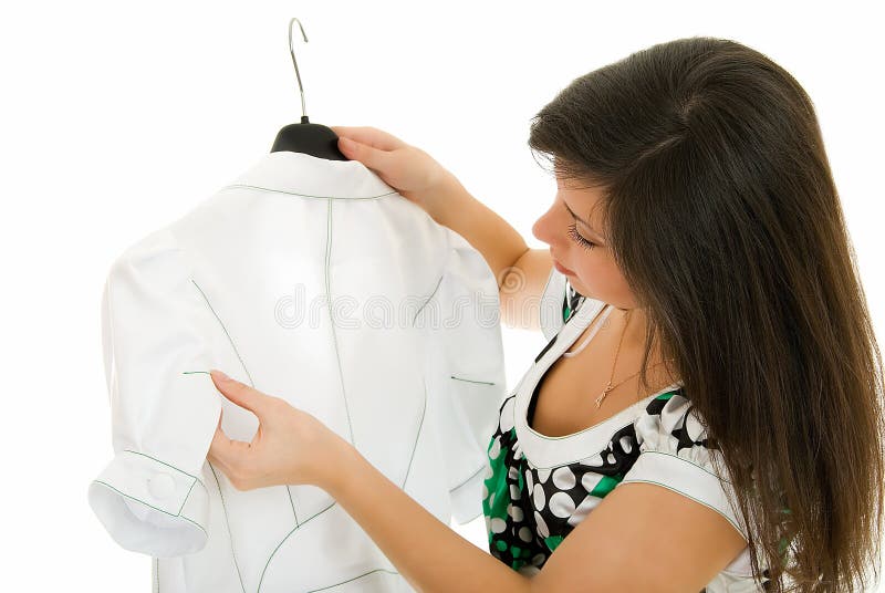 Young girl views white jacket on white background. Young girl views white jacket on white background