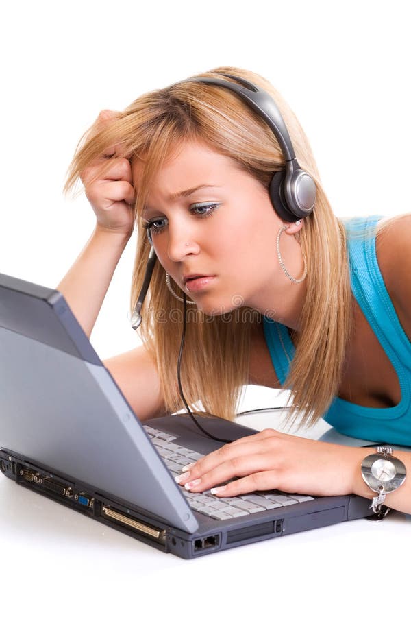 Beautiful confused teenage girl, with a laptop and headphones, on white background. Beautiful confused teenage girl, with a laptop and headphones, on white background