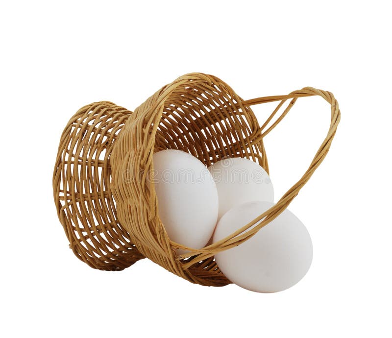 Three white eggs spilled from straw interwoven basket isolated on white background. Three white eggs spilled from straw interwoven basket isolated on white background