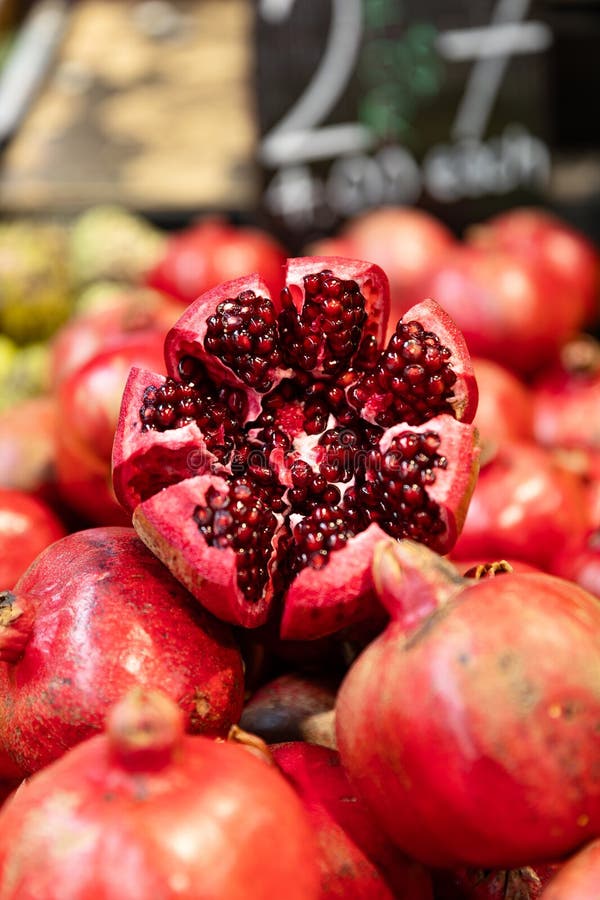 Mouthwatering pomegranate at a farmers market. Staged to perfection to attract customers to the stall. Mouthwatering pomegranate at a farmers market. Staged to perfection to attract customers to the stall.