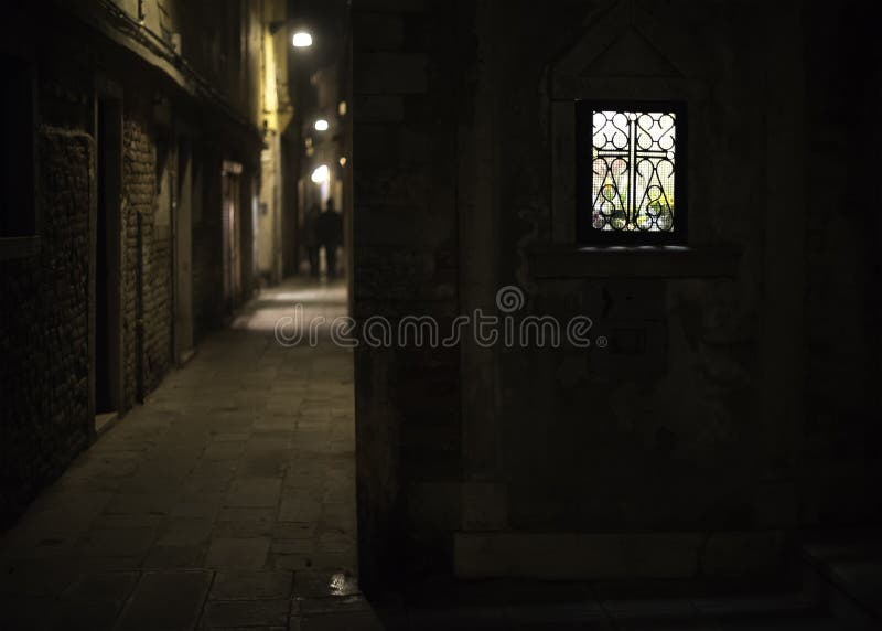 Brightly lit window in a narrow alley of Venice at night. Brightly lit window in a narrow alley of Venice at night