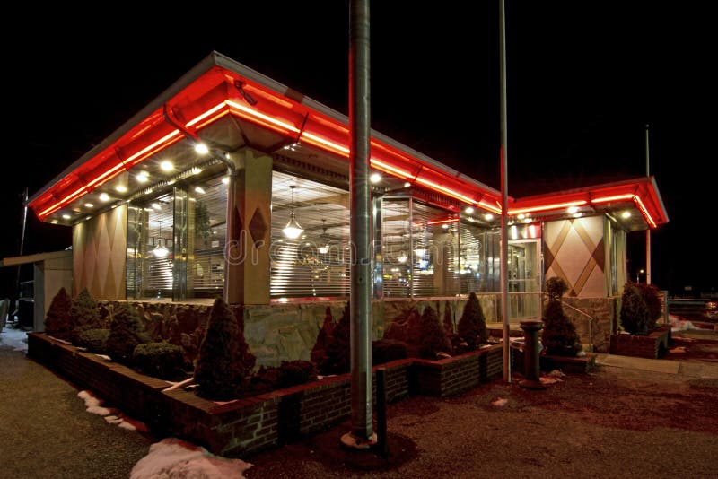 Brightly lit traditional retro vintage diner restaurant at night. Brightly lit traditional retro vintage diner restaurant at night