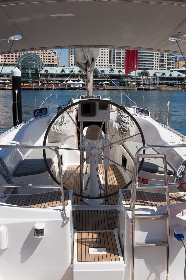 A moored yacht in a marina showing the helm. A moored yacht in a marina showing the helm
