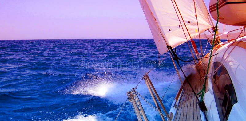 Side view of yacht sailing in blue sea with copy space. Side view of yacht sailing in blue sea with copy space.