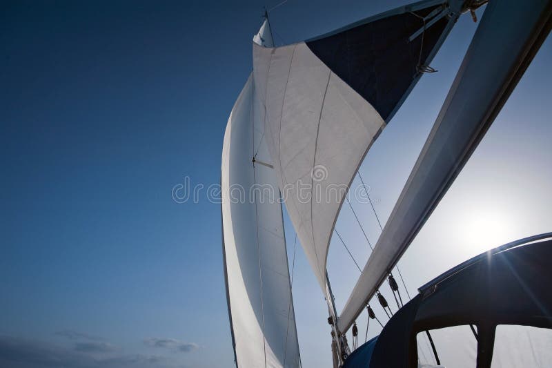 Wind in yacht sails with beautiful cloudless sky in the background. Wind in yacht sails with beautiful cloudless sky in the background