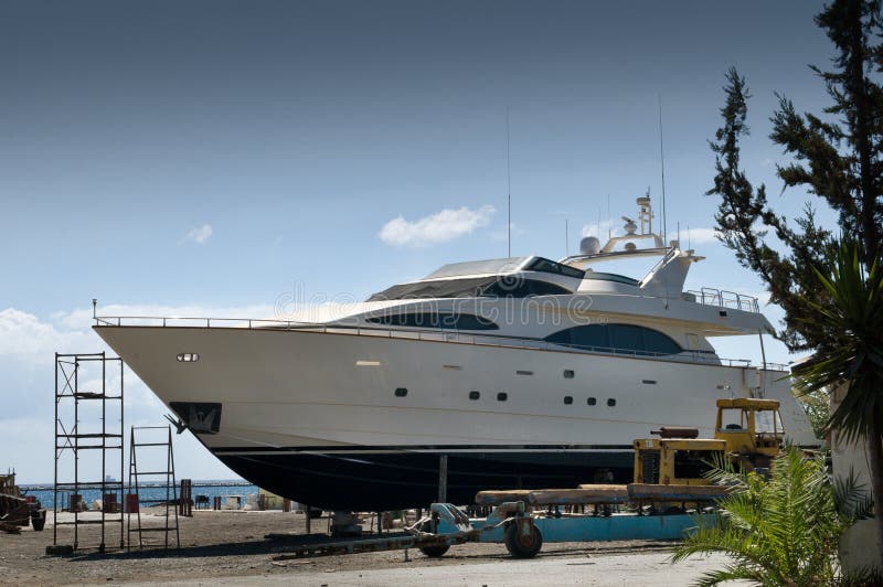Luxury yacht in the dry dock for small repair and general maintenance. Luxury yacht in the dry dock for small repair and general maintenance.