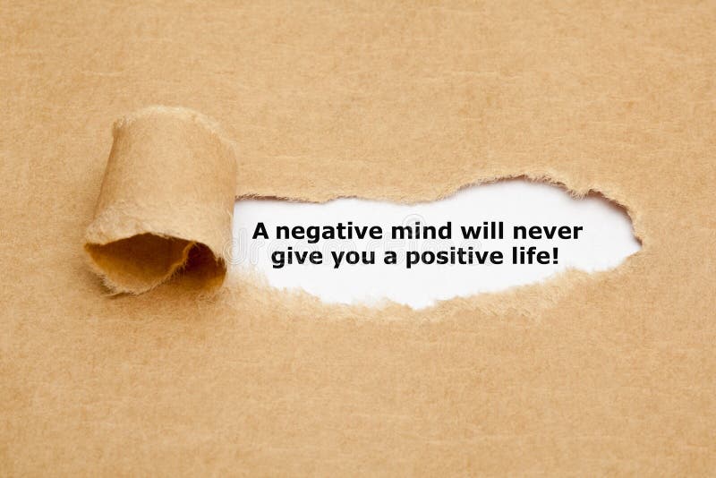 The text A negative mind will never give you a positive life, appearing behind torn brown paper. The text A negative mind will never give you a positive life, appearing behind torn brown paper.