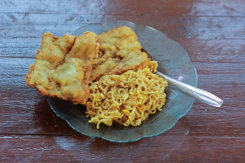photo of fried noodles with 2 fried tempeh that served for breakfast. photo of fried noodles with 2 fried tempeh that served for breakfast