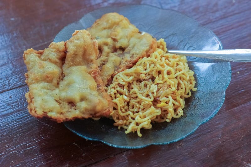 photo of fried noodles with 2 fried tempeh that served for breakfast. photo of fried noodles with 2 fried tempeh that served for breakfast