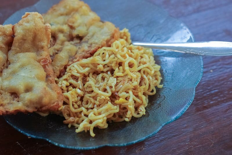 photo of fried noodles with 2 fried tempeh that served for breakfast. photo of fried noodles with 2 fried tempeh that served for breakfast