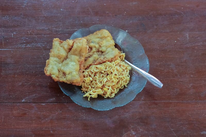 photo of fried noodles with 2 fried tempeh that served for breakfast. photo of fried noodles with 2 fried tempeh that served for breakfast