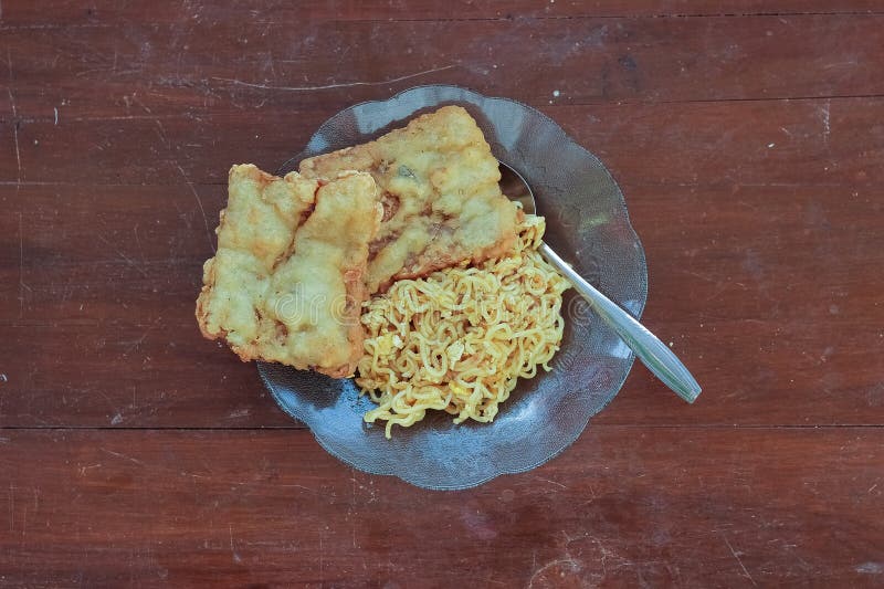 photo of fried noodles with 2 fried tempeh that served for breakfast. photo of fried noodles with 2 fried tempeh that served for breakfast