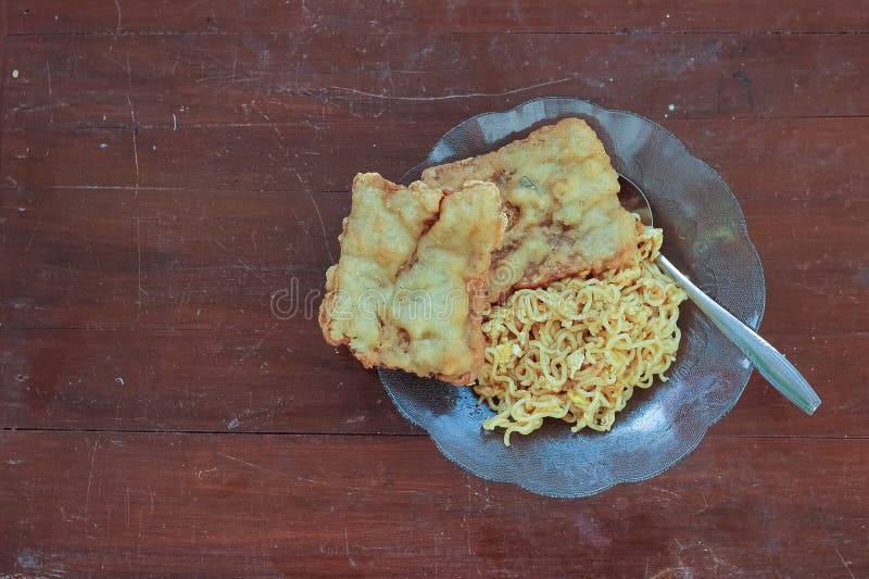 photo of fried noodles with 2 fried tempeh that served for breakfast. photo of fried noodles with 2 fried tempeh that served for breakfast