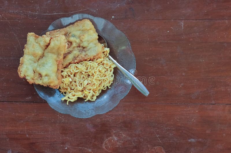 photo of fried noodles with 2 fried tempeh that served for breakfast. photo of fried noodles with 2 fried tempeh that served for breakfast