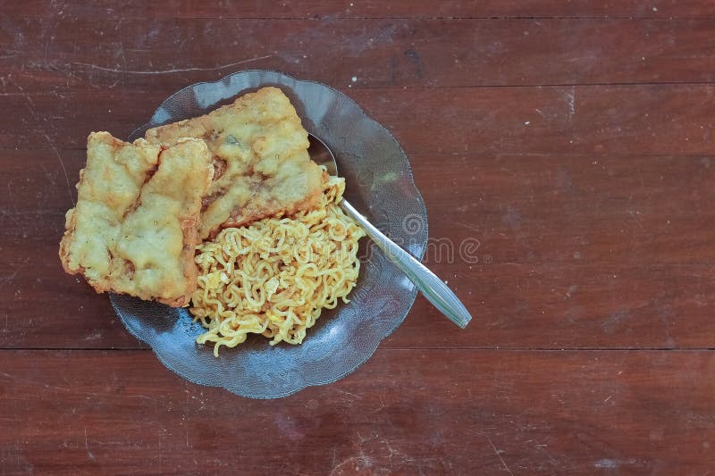 photo of fried noodles with 2 fried tempeh that served for breakfast. photo of fried noodles with 2 fried tempeh that served for breakfast