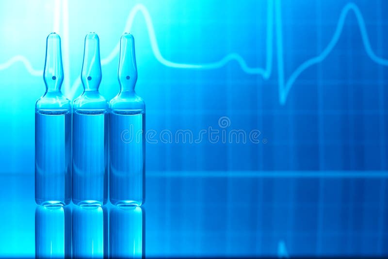 Ampoules filled with medicine and EKG in background. Ampoules filled with medicine and EKG in background