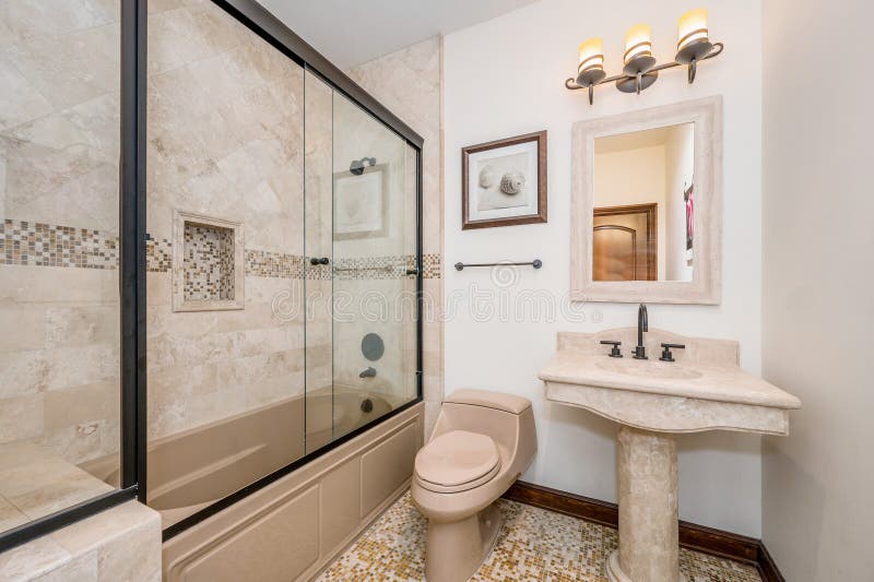 Bathroom with white walls, beige tile flooring, tub, and vanity. Bathroom with white walls, beige tile flooring, tub, and vanity