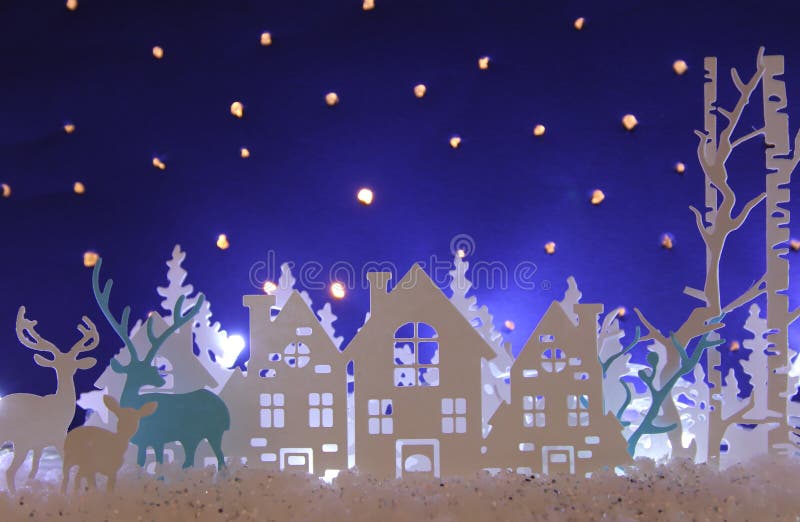 Magical Christmas paper cut winter background landscape with houses, trees, deer and snow in front of night starry sky background. Magical Christmas paper cut winter background landscape with houses, trees, deer and snow in front of night starry sky background