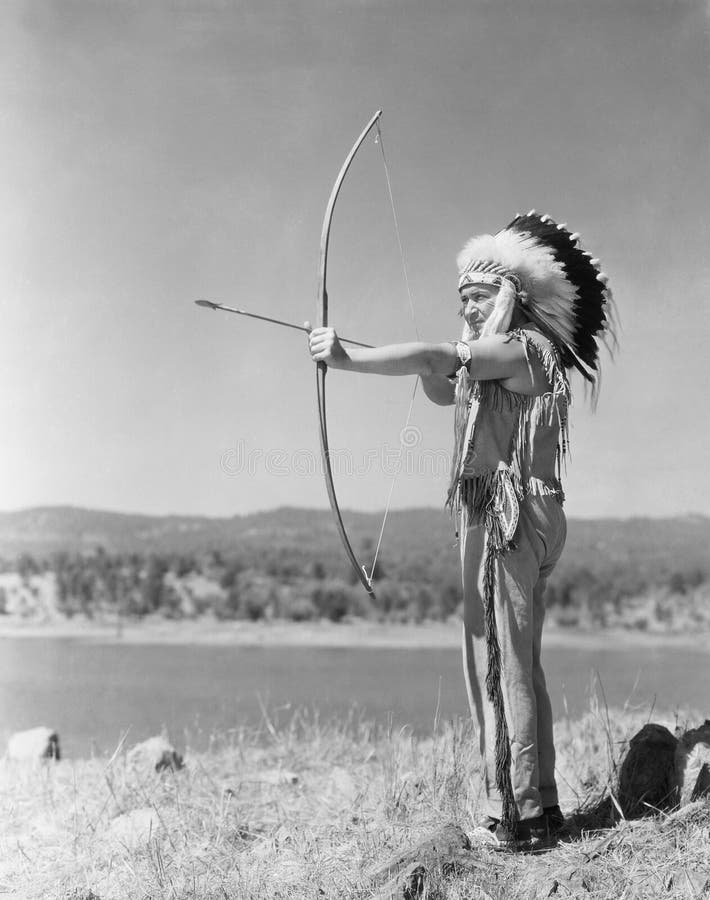 Man shooting with bow and arrow (All persons depicted are no longer living and no estate exists. Supplier grants that there will be no model release issues.). Man shooting with bow and arrow (All persons depicted are no longer living and no estate exists. Supplier grants that there will be no model release issues.)