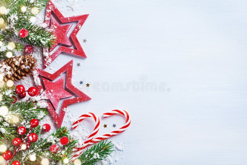 Christmas background with stars, snowy fir branches, cones and bokeh lights. Holiday banner or greeting card. Christmas background with stars, snowy fir branches, cones and bokeh lights. Holiday banner or greeting card