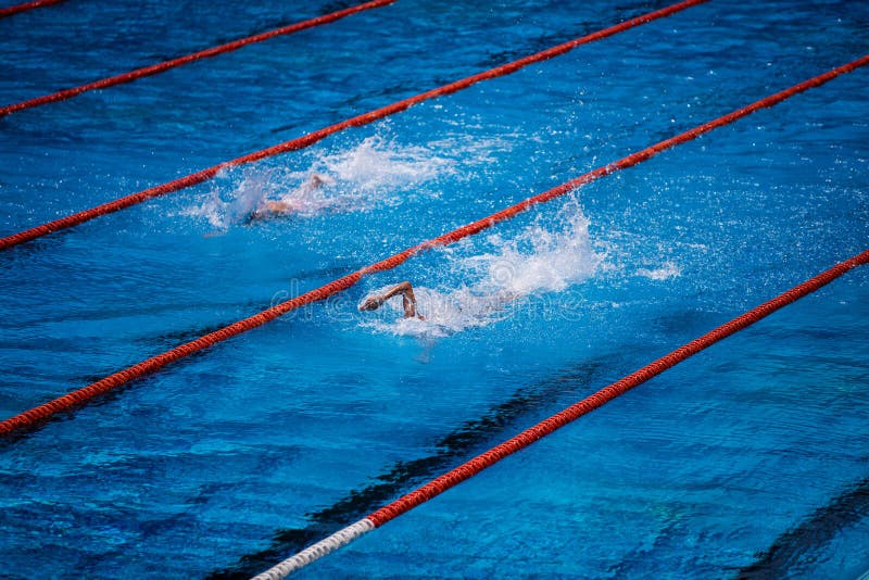 Empty olympic swimming pool with clear blue water and swimmer crawl race. Empty olympic swimming pool with clear blue water and swimmer crawl race