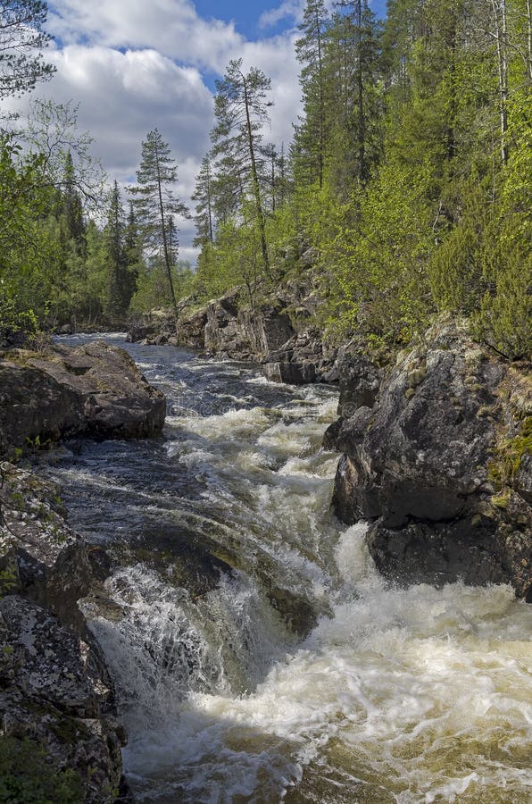 Rapids with waterfall on the mountain river Vuosnayoki, the border of the Murmansk region and Karelia, Russia. Rapids with waterfall on the mountain river Vuosnayoki, the border of the Murmansk region and Karelia, Russia.
