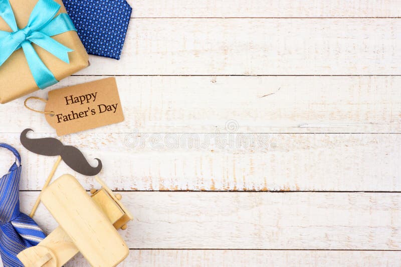 Happy Fathers Day gift tag with side border of gifts, ties and decor on a white wood background. Top view with copy space. Happy Fathers Day gift tag with side border of gifts, ties and decor on a white wood background. Top view with copy space.