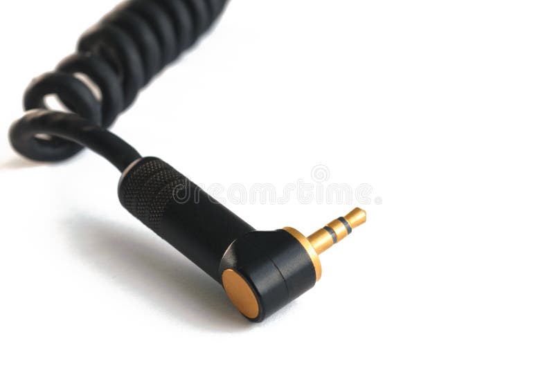 Black audio instrumental cable with gold stereo 3.5mm plugs isolated on white closeup. Black audio instrumental cable with gold stereo 3.5mm plugs isolated on white closeup