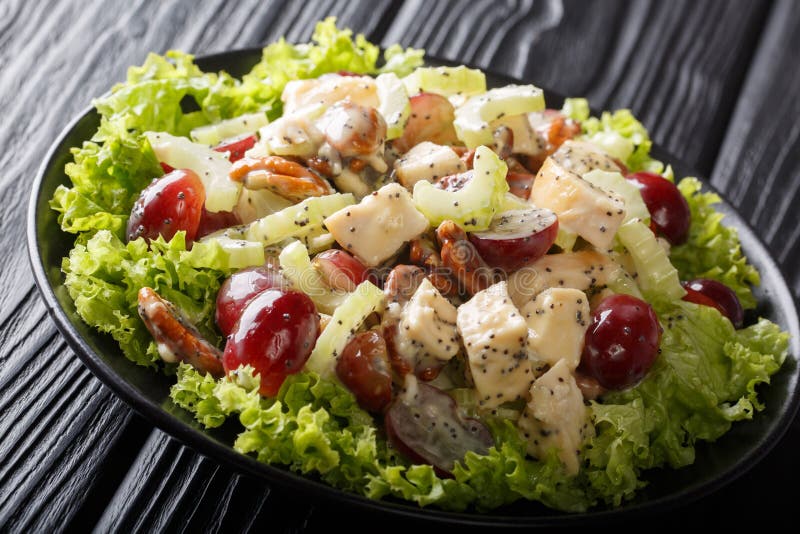 Sonoma salad with chicken breast, celery, Pecan and grapes served with green lettuce close-up on a plate on the table. horizontal. Sonoma salad with chicken breast, celery, Pecan and grapes served with green lettuce close-up on a plate on the table. horizontal