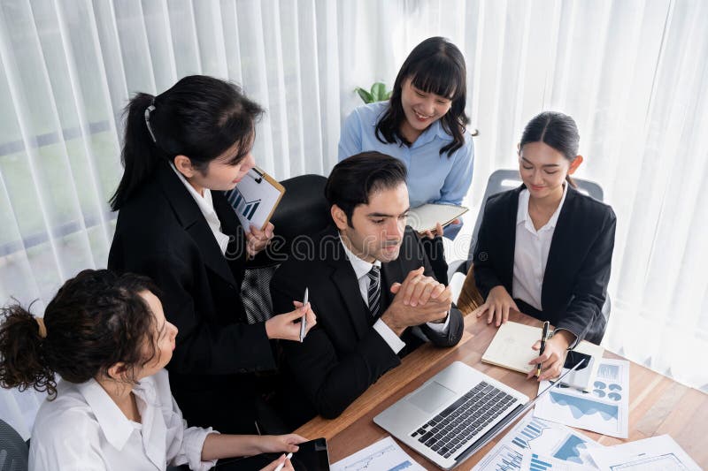 Diverse group of business analyst team analyzing financial data report paper on office table. Chart and graph dashboard by business intelligence analysis for strategic marketing planning Meticulous. Diverse group of business analyst team analyzing financial data report paper on office table. Chart and graph dashboard by business intelligence analysis for strategic marketing planning Meticulous