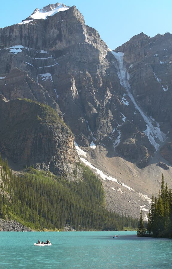 Canoeing at Moraine lake. Alberta. Canada. Vertical. Canoeing at Moraine lake. Alberta. Canada. Vertical