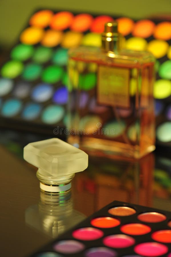 Close up on a perfuem bottle cork with a colorful cosmetics background. Close up on a perfuem bottle cork with a colorful cosmetics background