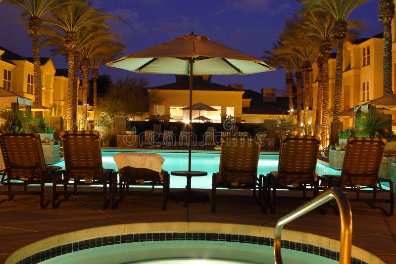 The bright blue pool and courtyard of a resort in Scottsdale, Arizona at dusk. The bright blue pool and courtyard of a resort in Scottsdale, Arizona at dusk.