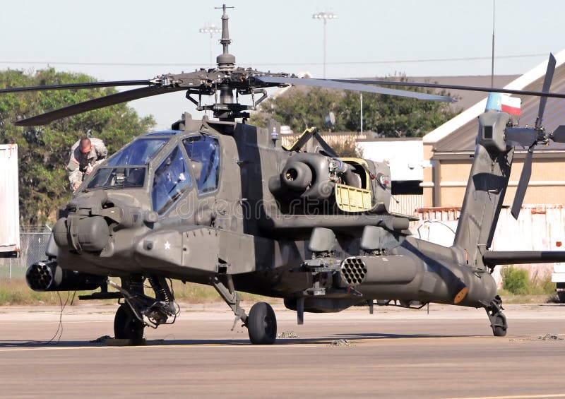 Houston, USA - November 1, 2009: Texas National Guard pilot preparing his Apache helicopter for flight at Ellington Air Force Base. Houston, USA - November 1, 2009: Texas National Guard pilot preparing his Apache helicopter for flight at Ellington Air Force Base