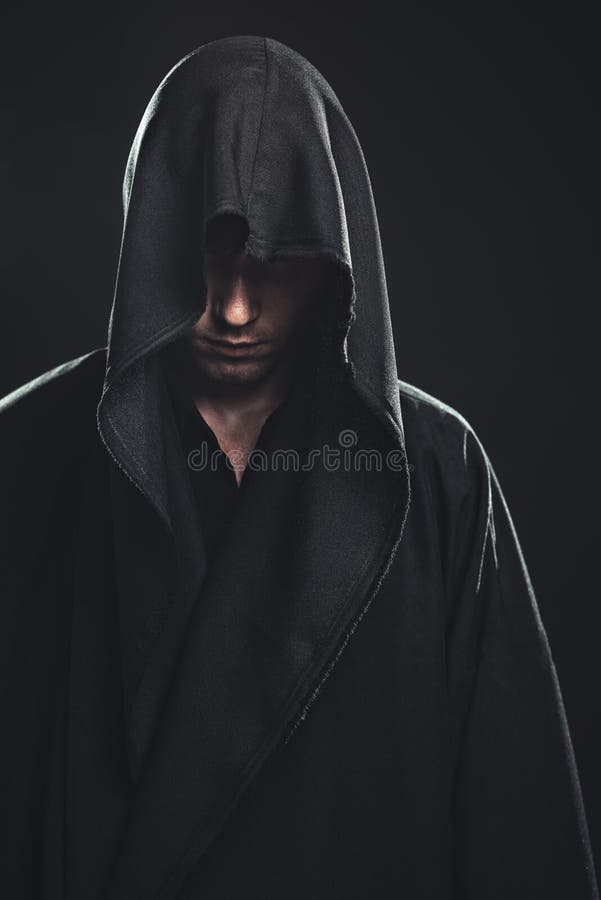 Portrait of a Man in a black robe on a dark background. Portrait of a Man in a black robe on a dark background